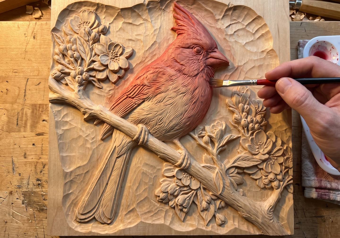 The first thin red wash going onto the cardinal, the head and back tinted while the tail and breast are still bare wood