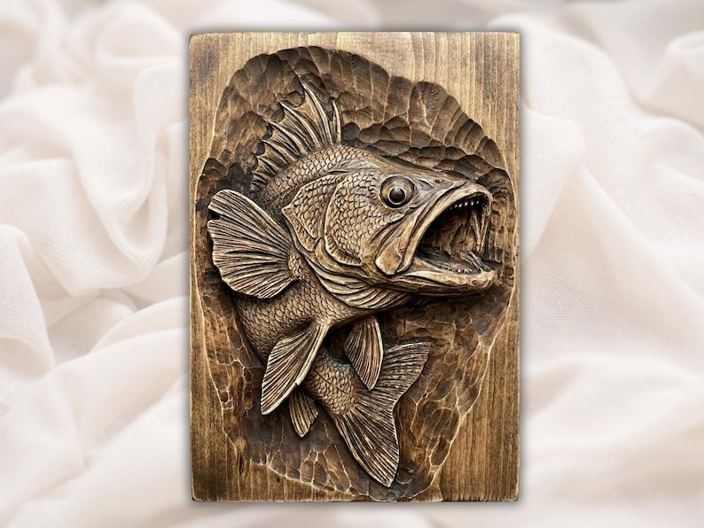 Carved wood bas-relief of a largemouth bass with open mouth and flared fins leaping from a panel