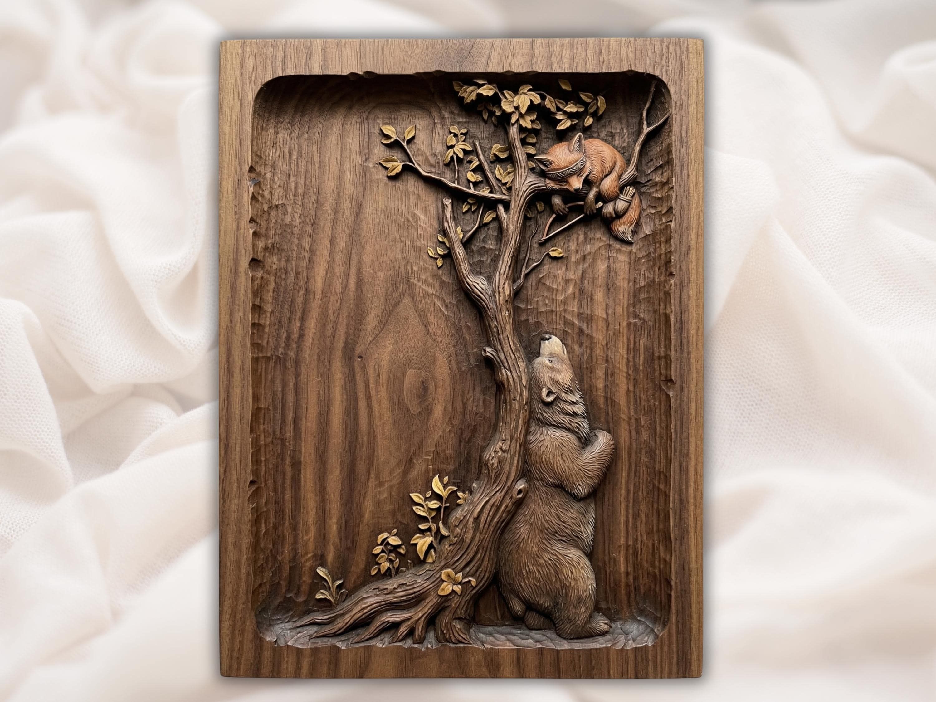 Wood bas-relief carving of a bear standing against a tree with a fox resting on the branches above