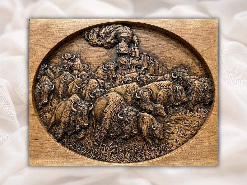 Carved oval wood relief of a running bison herd with a vintage steam train and smoke behind them
