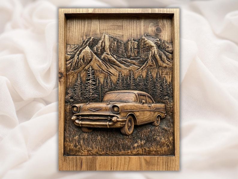 Carved wood relief of a classic 1957 Chevy car with mountains and pine trees in the background.