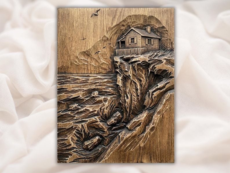 Carved wood bas-relief of a small cabin on a rocky ocean cliff with crashing waves and birds in the sky