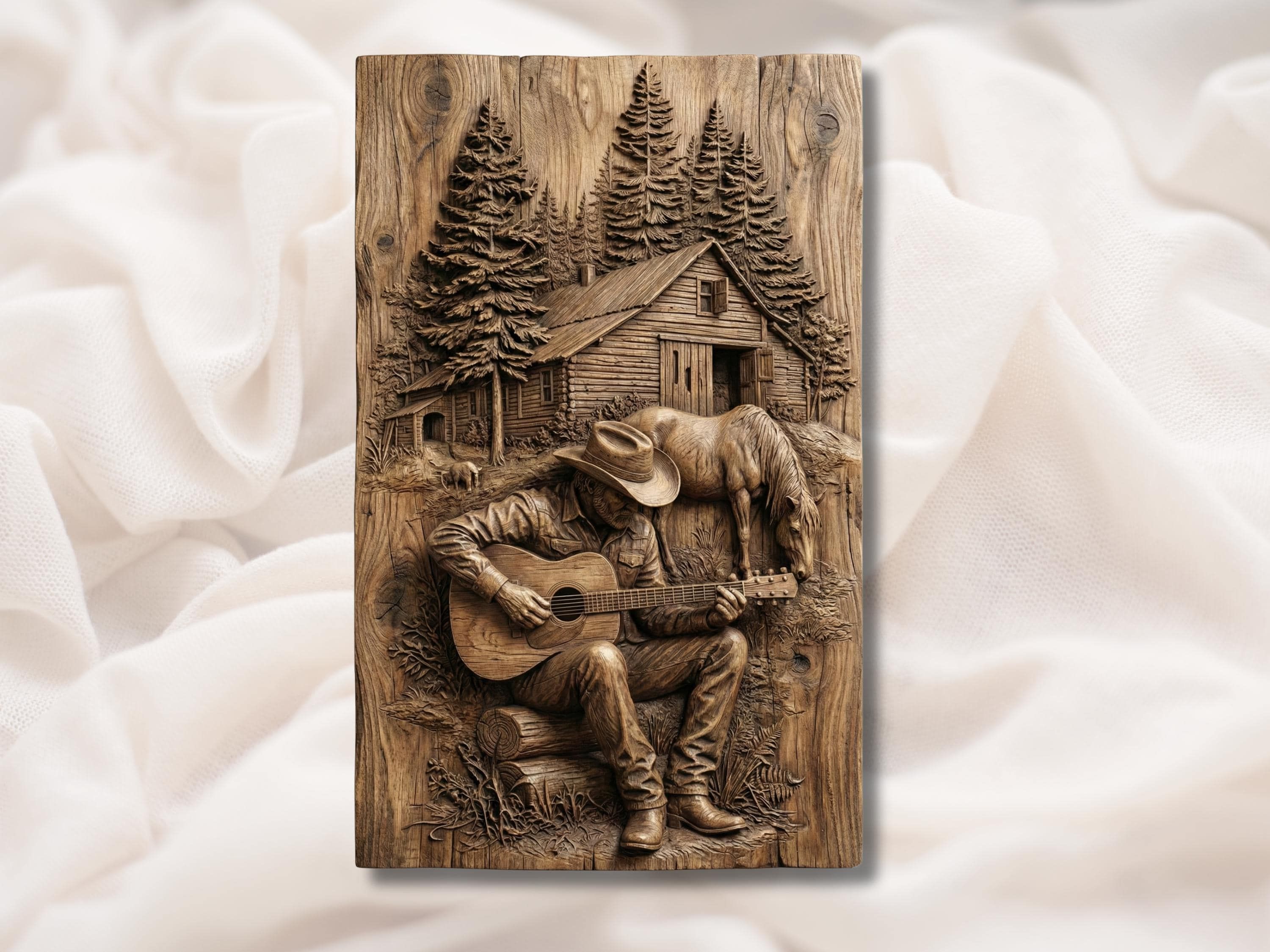 Carved wood relief of a cowboy playing guitar with a grazing horse, log cabin, and pine trees behind him.