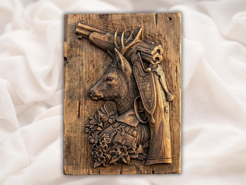 Carved wood relief of a roe buck head beside an engraved break-action shotgun with flowers below