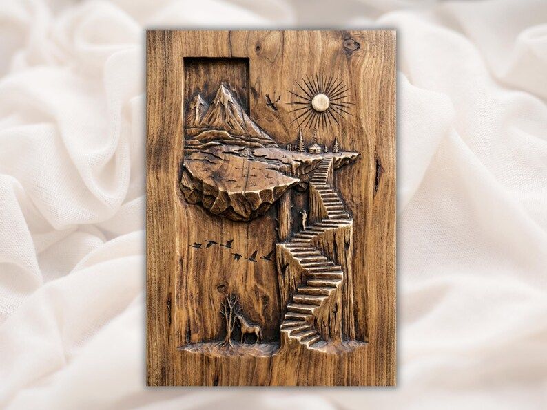 Bas-relief wood carving of a floating island with a stone stairway, mountain, sun, birds, tree, and deer.