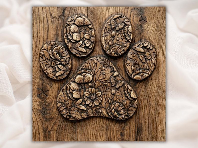 Carved wooden paw print with each pad filled with flowers, leaves, and butterflies in bas-relief.