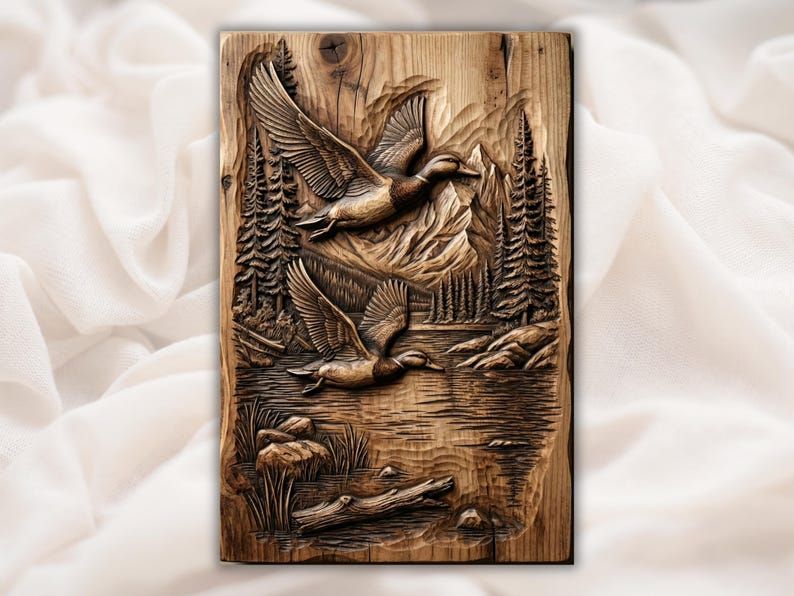 Carved wood bas-relief of two ducks flying over a mountain lake with pine trees and a rocky shore.