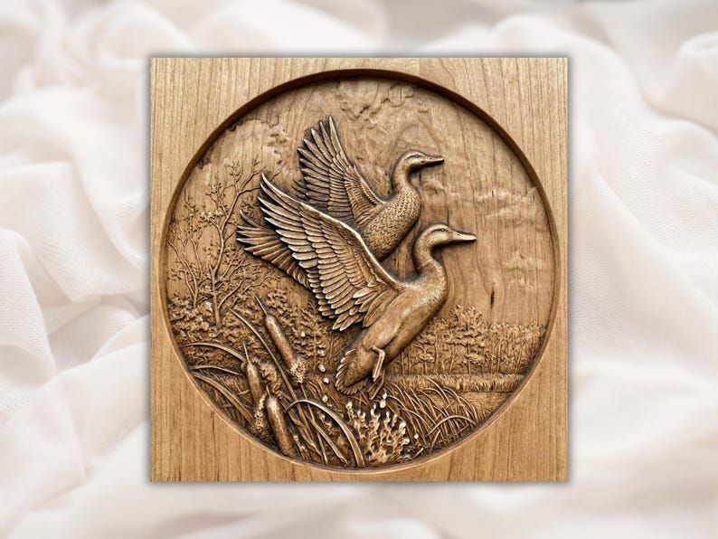 Round wood carving of two flying mallard ducks rising over marsh reeds and cattails, bas-relief panel
