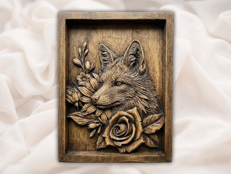 Carved wood bas-relief of a fox head above a blooming rose with leaves, set in a recessed frame panel.