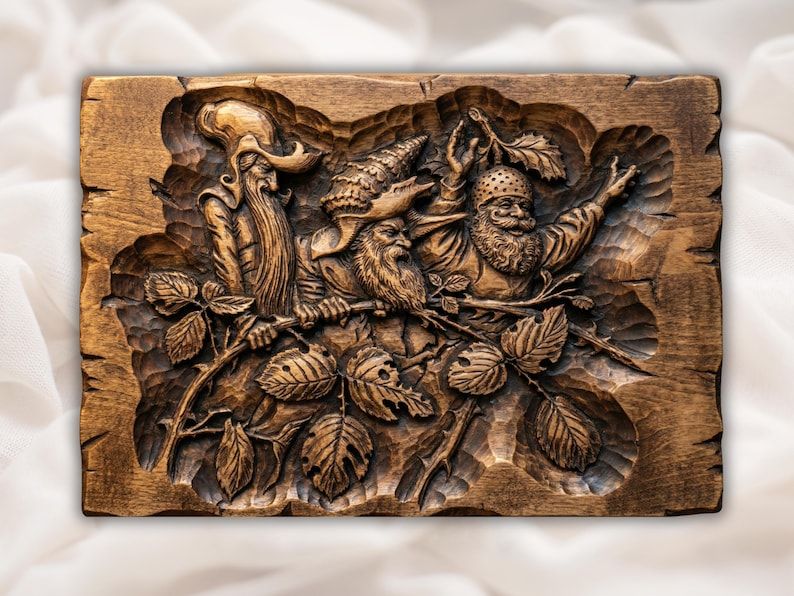 Carved wood bas-relief of three bearded gnomes in pointed hats perched on a leafy branch.