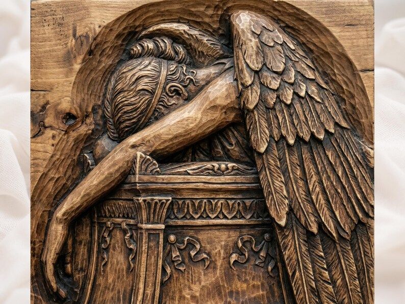 Carved wood bas-relief of a weeping angel draped over a stone monument with a large feathered wing