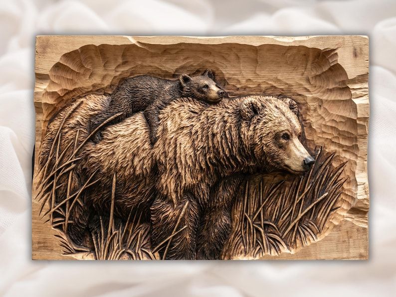 Carved wood bas-relief of a grizzly bear mother walking through grass with a cub resting on her back