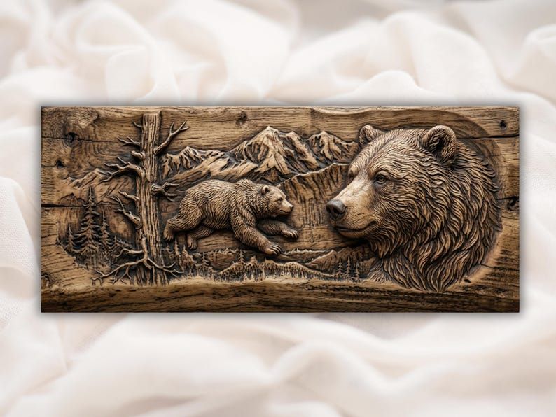 Bas-relief wood carving of a grizzly bear head with a running cub, pine tree, and snowy mountains.