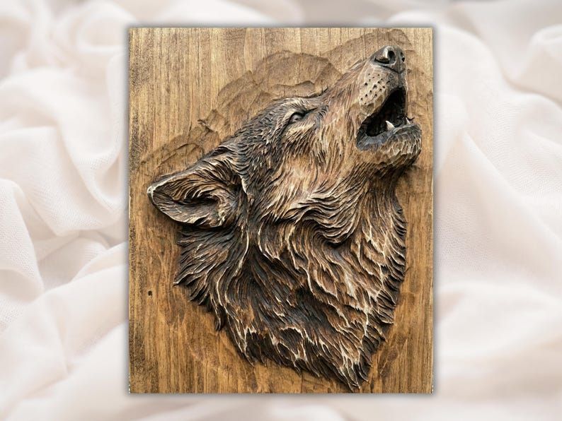 Carved wood bas-relief of a wolf head howling with detailed fur, mounted on a vertical wood-grain panel