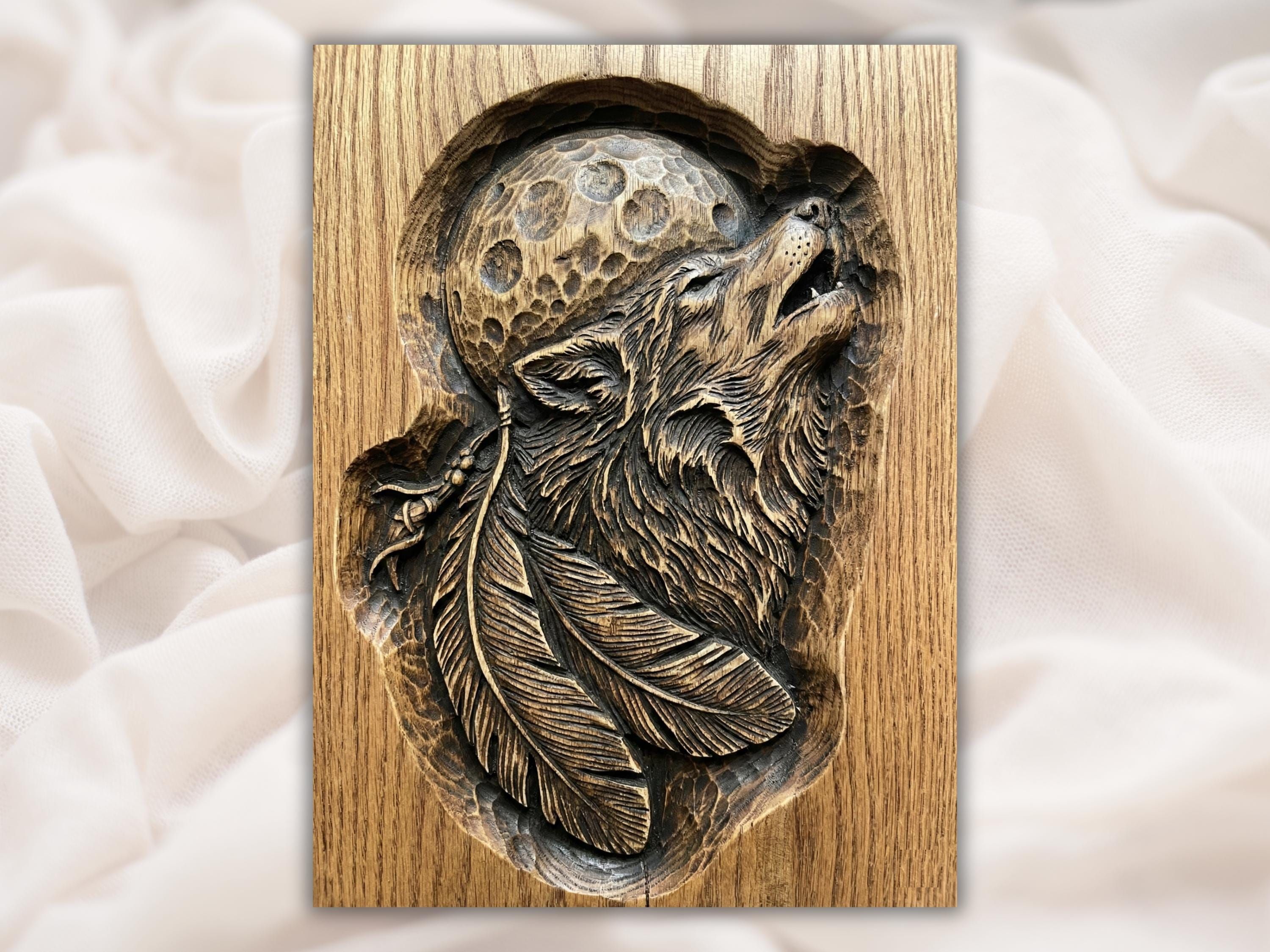 Wood bas-relief of a howling wolf head with layered feathers below and a cratered full moon behind