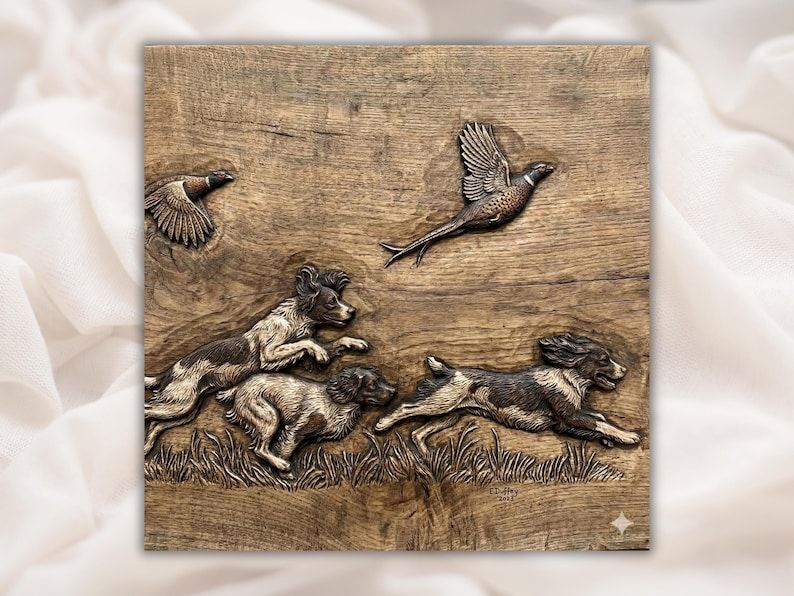 Bas-relief wood carving of two spaniels running through grass chasing two flying pheasants