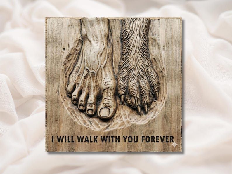 Carved wood relief of a bare human foot beside a dog paw in sand with text I Will Walk With You Forever