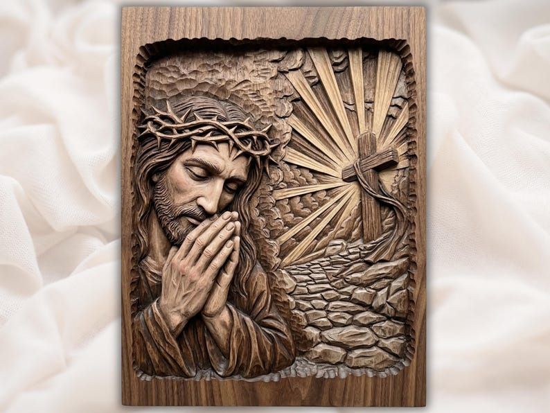 Bas-relief carving of Jesus praying with crown of thorns beside a cross with radiant light and stone path