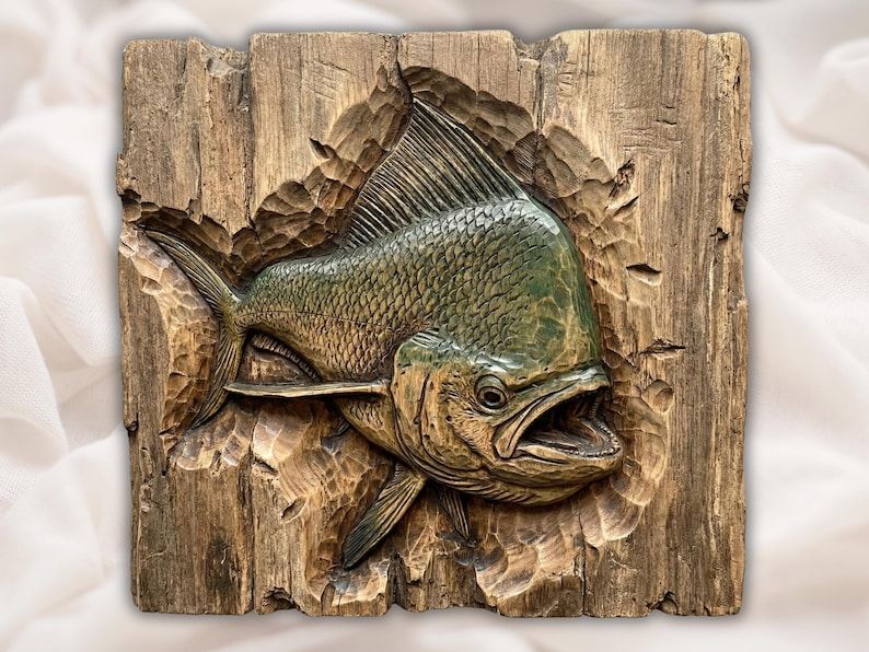 Carved bas-relief mahi mahi dolphinfish bursting out of a rustic wood panel, fin up and mouth open