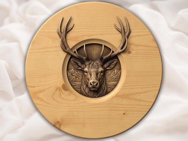 Carved relief of a stag deer head with large antlers in a recessed round panel with mountains behind it