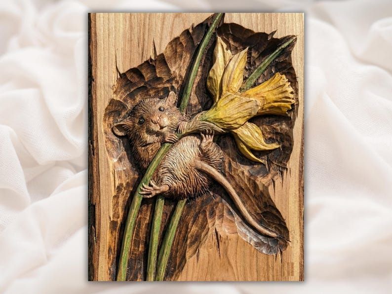 Bas-relief wood carving of a mouse clinging to a daffodil flower stem on a grained panel.