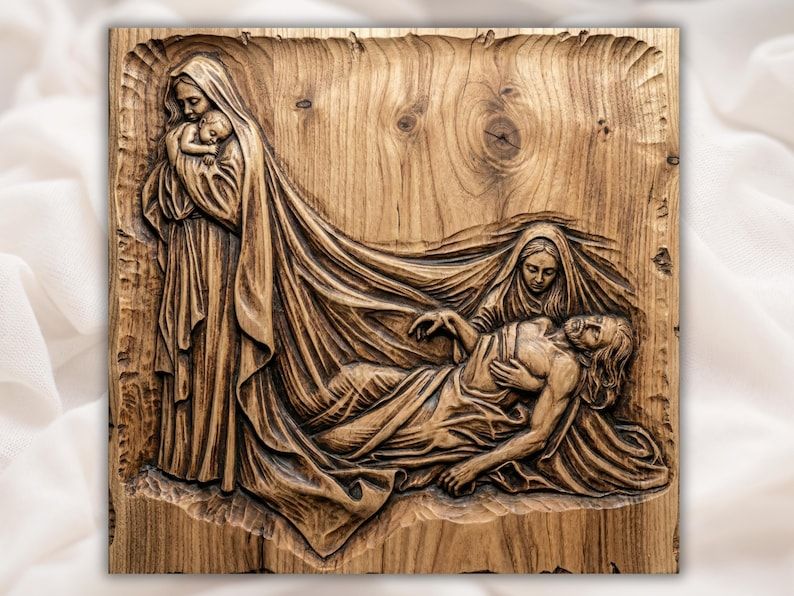 Carved wood bas-relief of Mary holding the infant Jesus beside the Pietà scene of Mary cradling Christ.