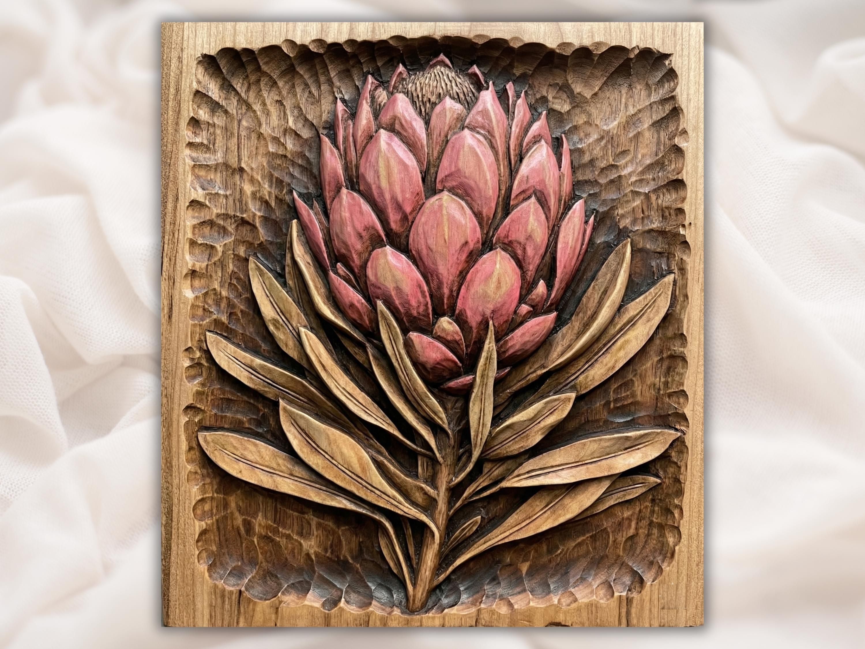 Carved wood bas-relief of a pink king protea flower with layered petals and long leaves
