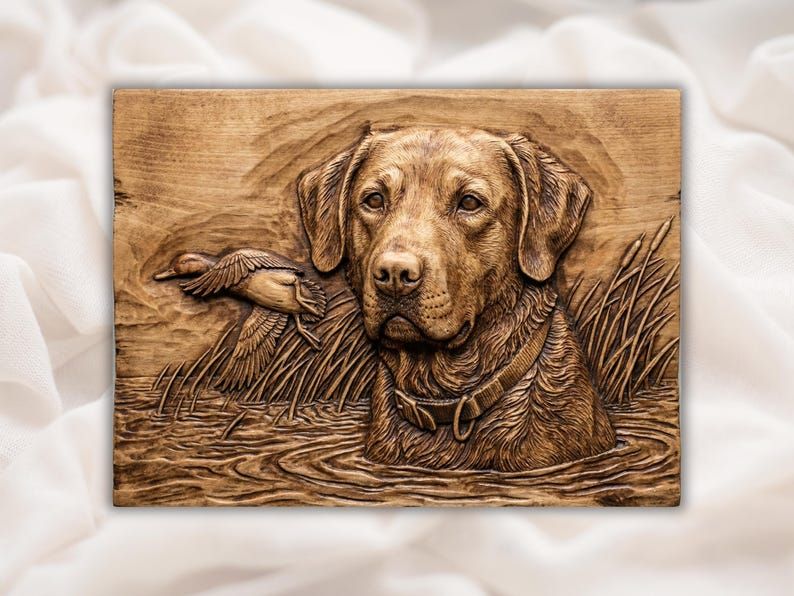 Carved wood relief of a Labrador retriever in marsh water with cattails and a duck flying behind him