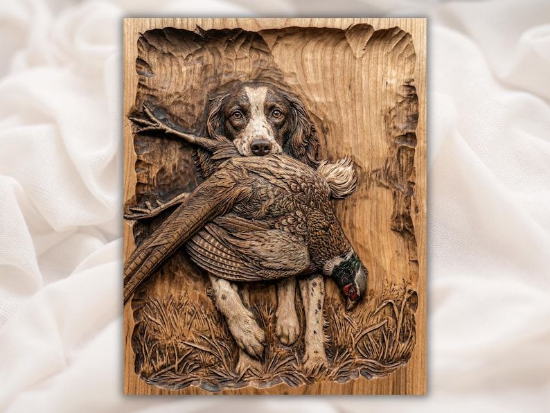 Carved wood relief of a spaniel gun dog carrying a pheasant in its mouth, standing in grass