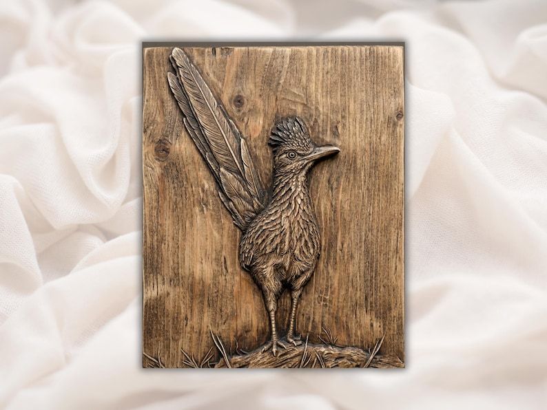 Carved wood bas-relief of a roadrunner bird standing on a branch with a long raised tail.