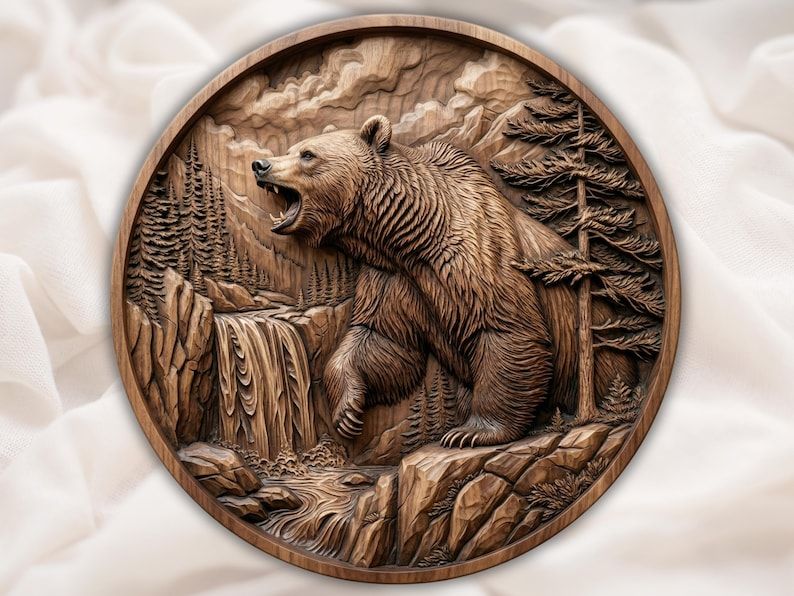 Round bas-relief carving of a roaring grizzly bear on rocks beside a waterfall with pine trees and mountains
