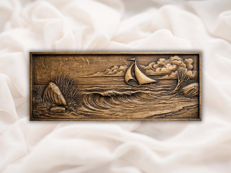 Carved wood relief of a sailboat riding ocean waves toward shoreline rocks with clouds behind the sail