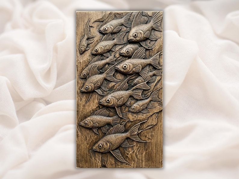 Carved wood bas-relief panel showing a flowing school of overlapping fish swimming underwater