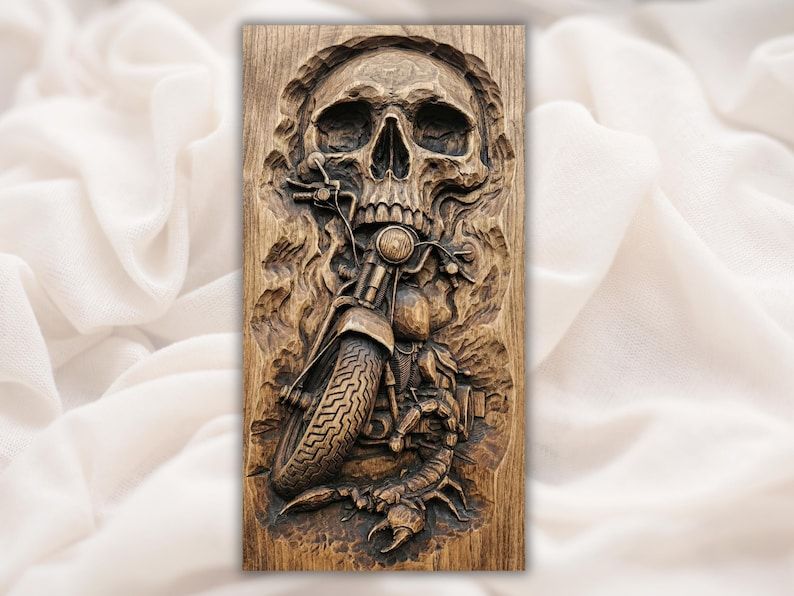 Carved wood relief of a skull above a chopper motorcycle with a scorpion near the front wheel