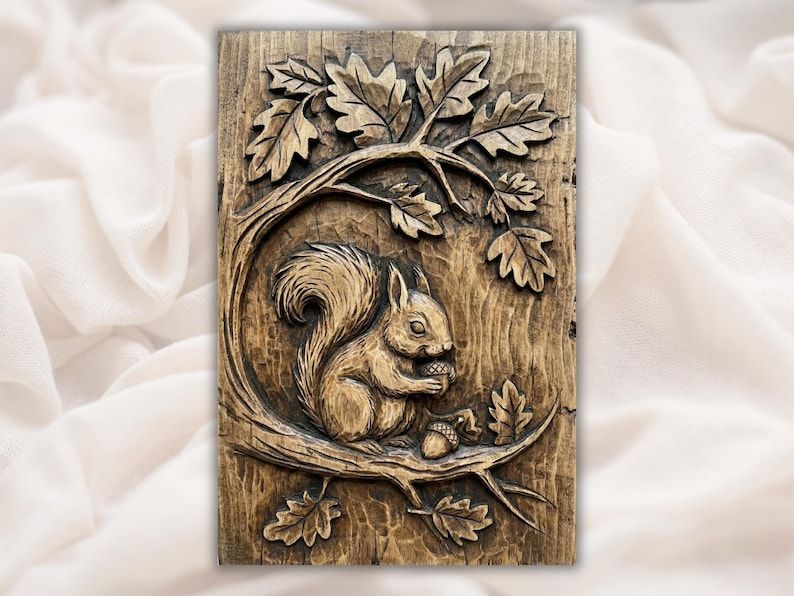 Bas-relief wood carving of a squirrel holding an acorn on a branch surrounded by oak leaves