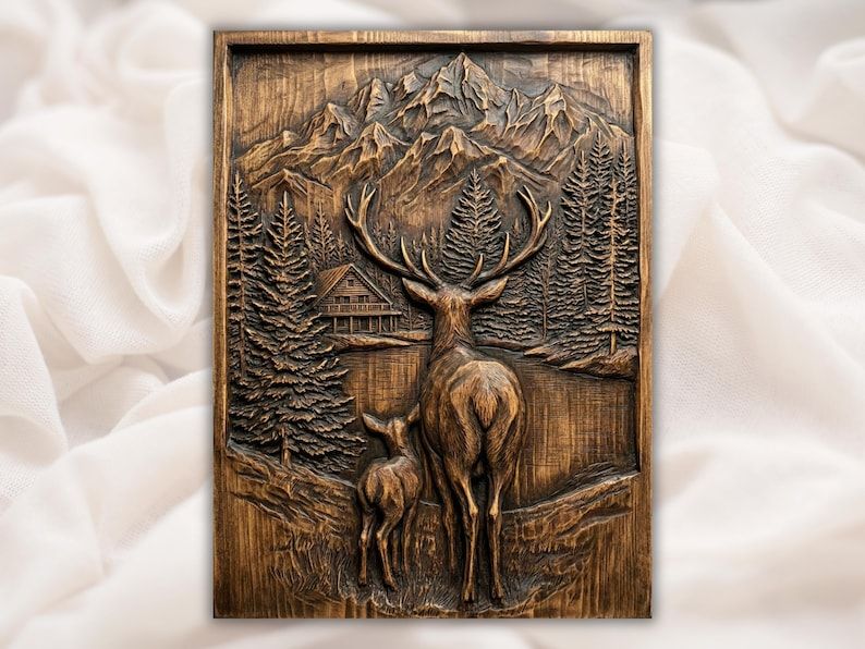Carved wood relief of a stag and fawn by a lake with pine trees, a cabin, and mountain peaks