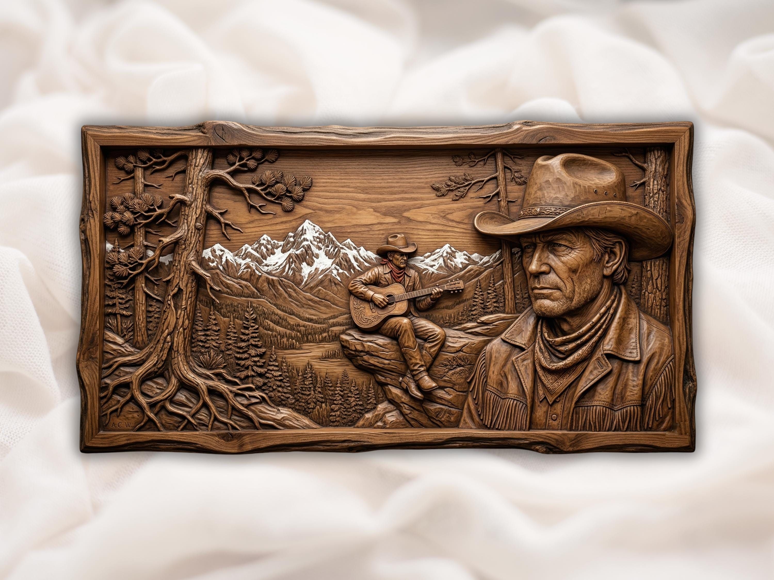 Bas-relief wood carving of a cowboy playing guitar on a rocky ridge with snowy mountains and pine forest behind.