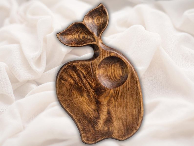 Carved wooden whale tail shaped serving board with a recessed tray and a round dip bowl