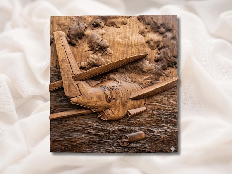 Carved wood bas-relief of a WWII fighter plane diving over the ocean with a falling bomb and smoke clouds